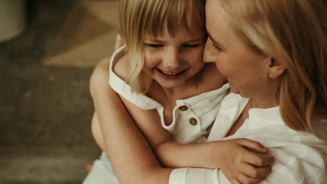 Mum cuddling her little girl